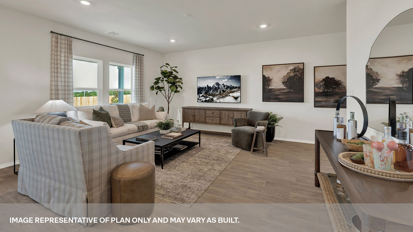 Living room with vinyl flooring and two windows opening to the kitchen.