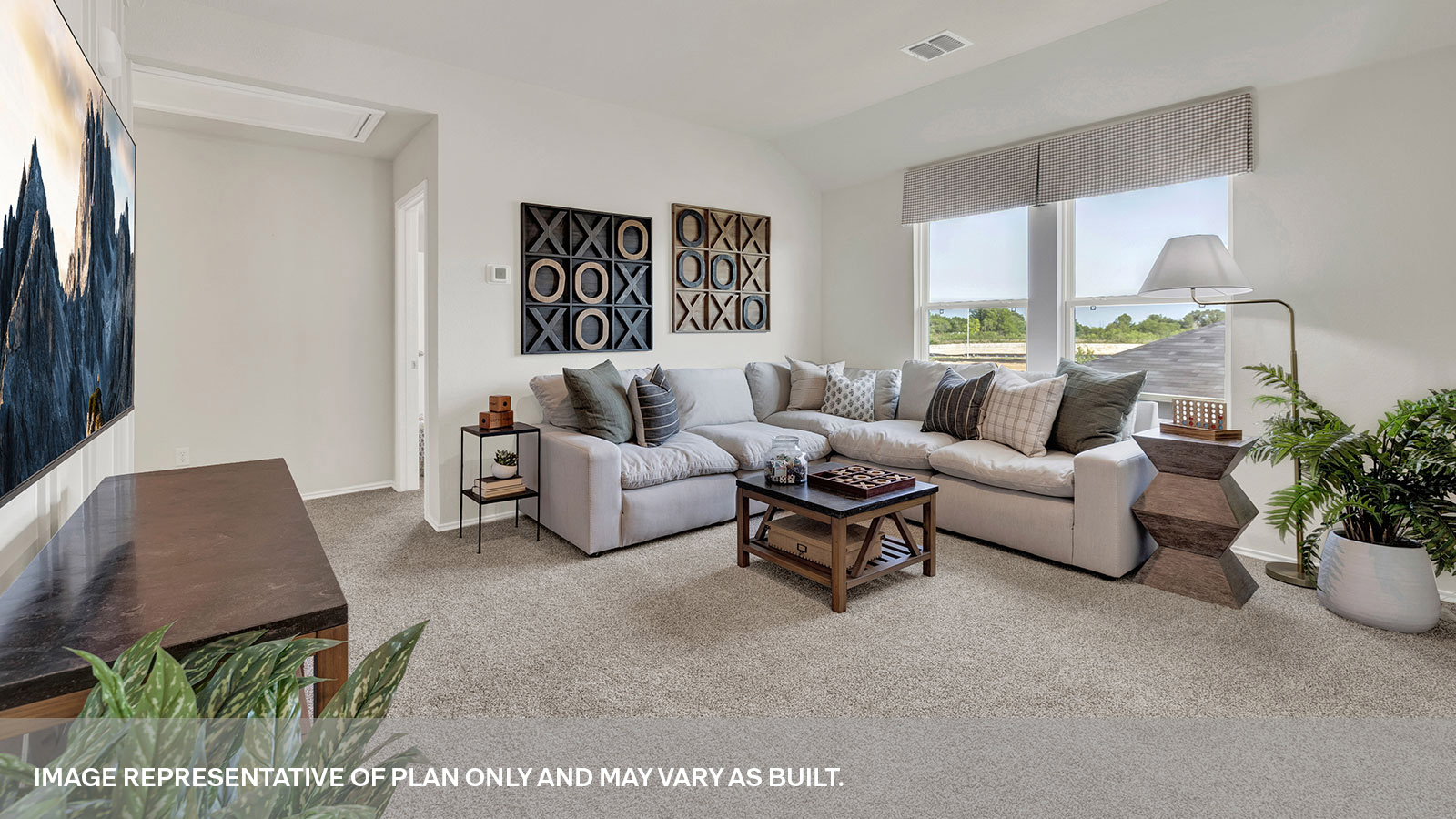 Gameroom of off the staircase with carpeting and two windows.