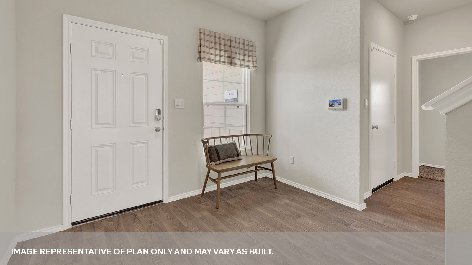 Entry hallway with vinyl flooring and front door.