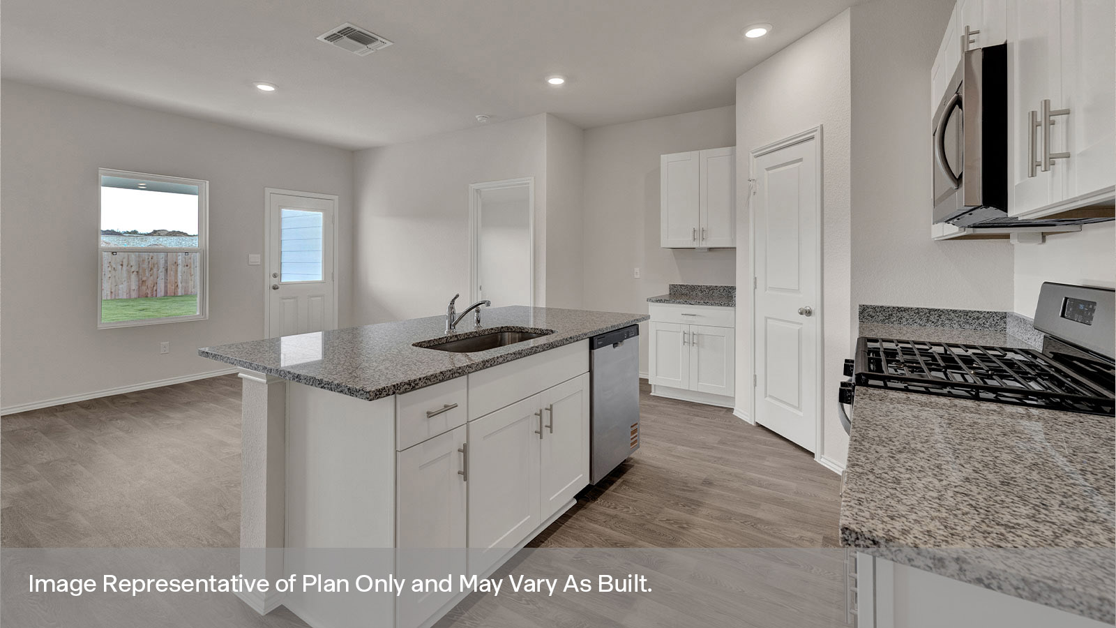 Kitchen with kitchen island and entry hallway.