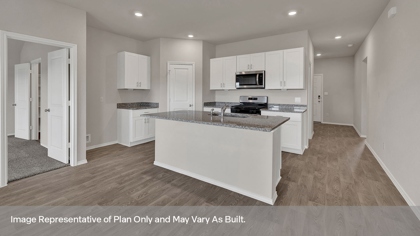 Kitchen with kitchen island and entry hallway.