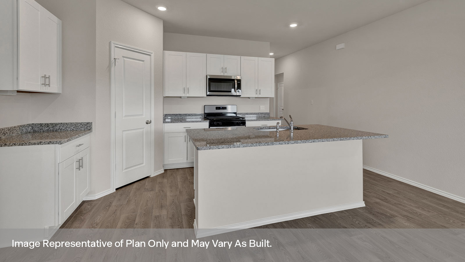 Kitchen with kitchen island and entry hallway.