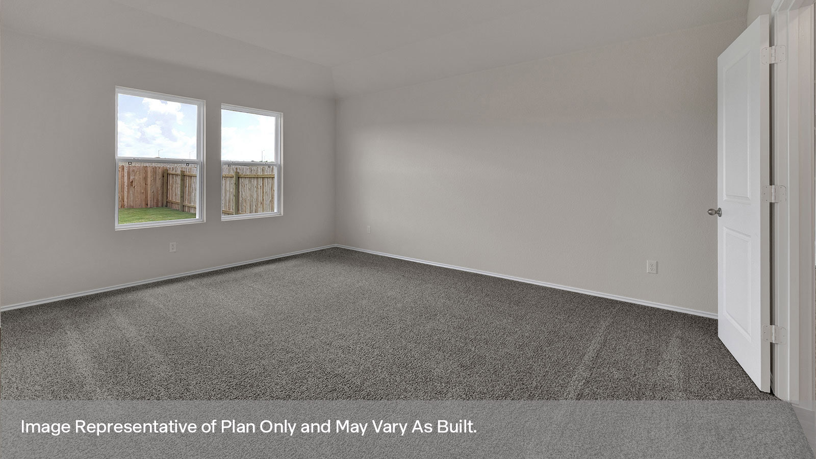 Main bedroom with carpeting and two windows.