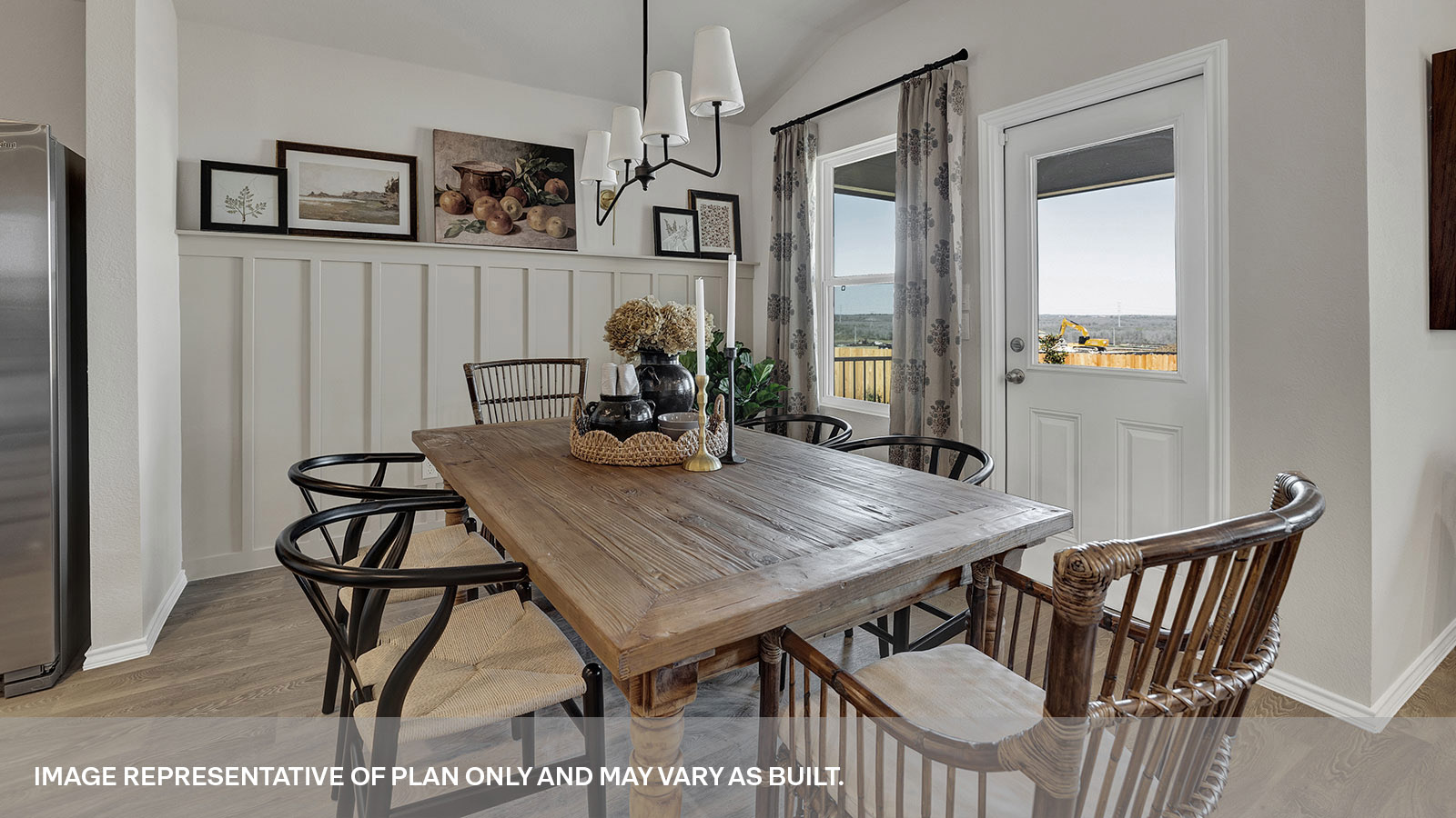 Dining room and living room with vinyl flooring, 3 windows, and half lite exterior door.