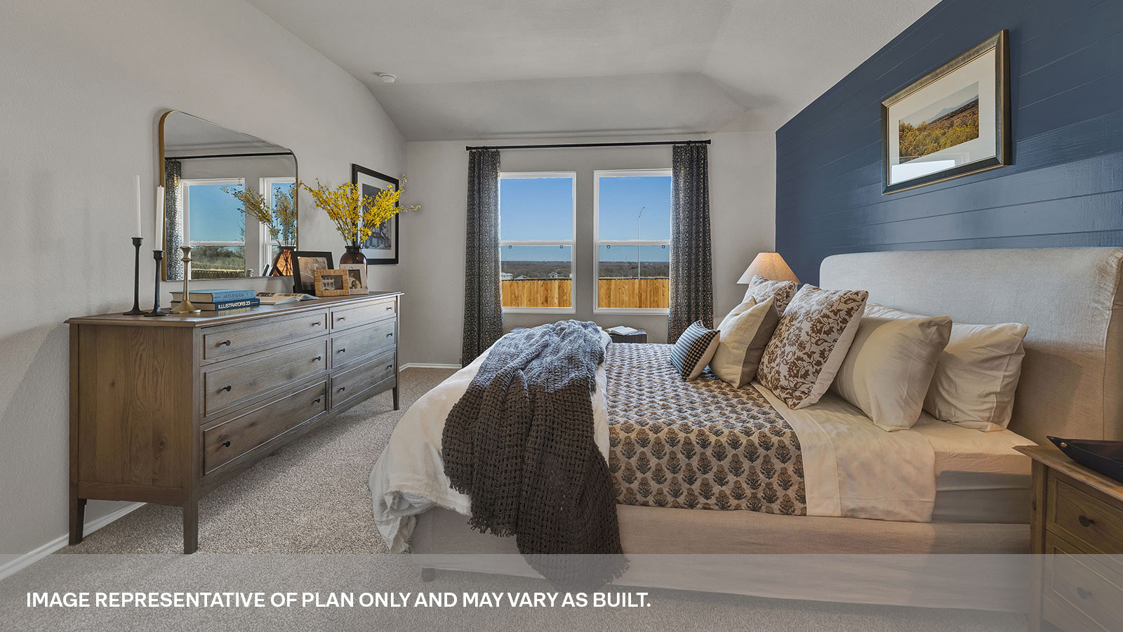 Main bedroom with carpeting and two windows.