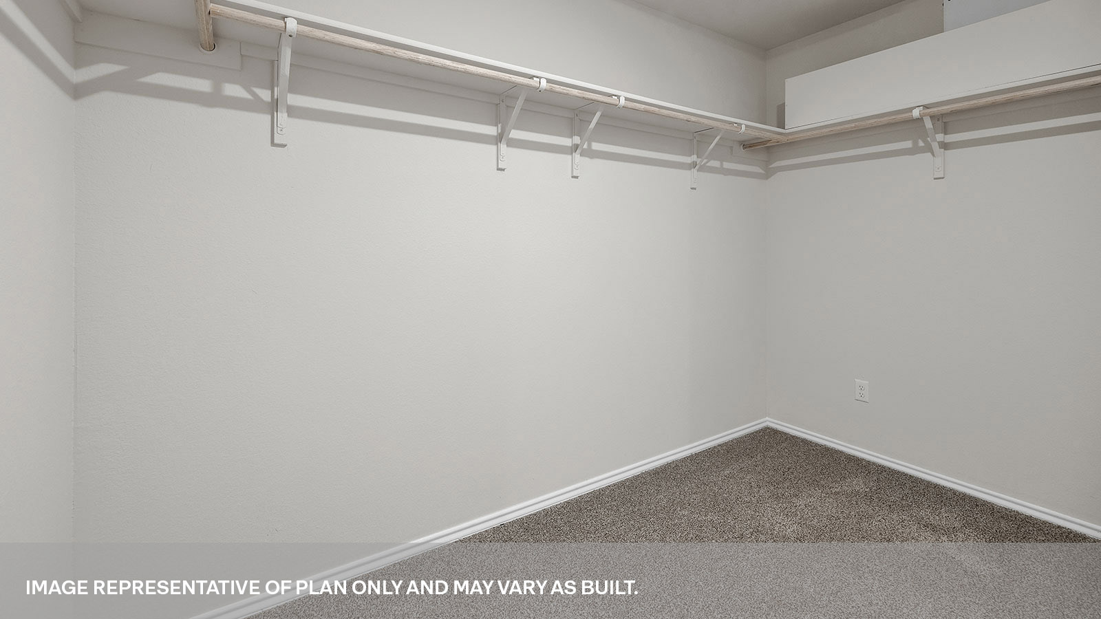 Main bedroom closet with carpeting and wooden shelving.