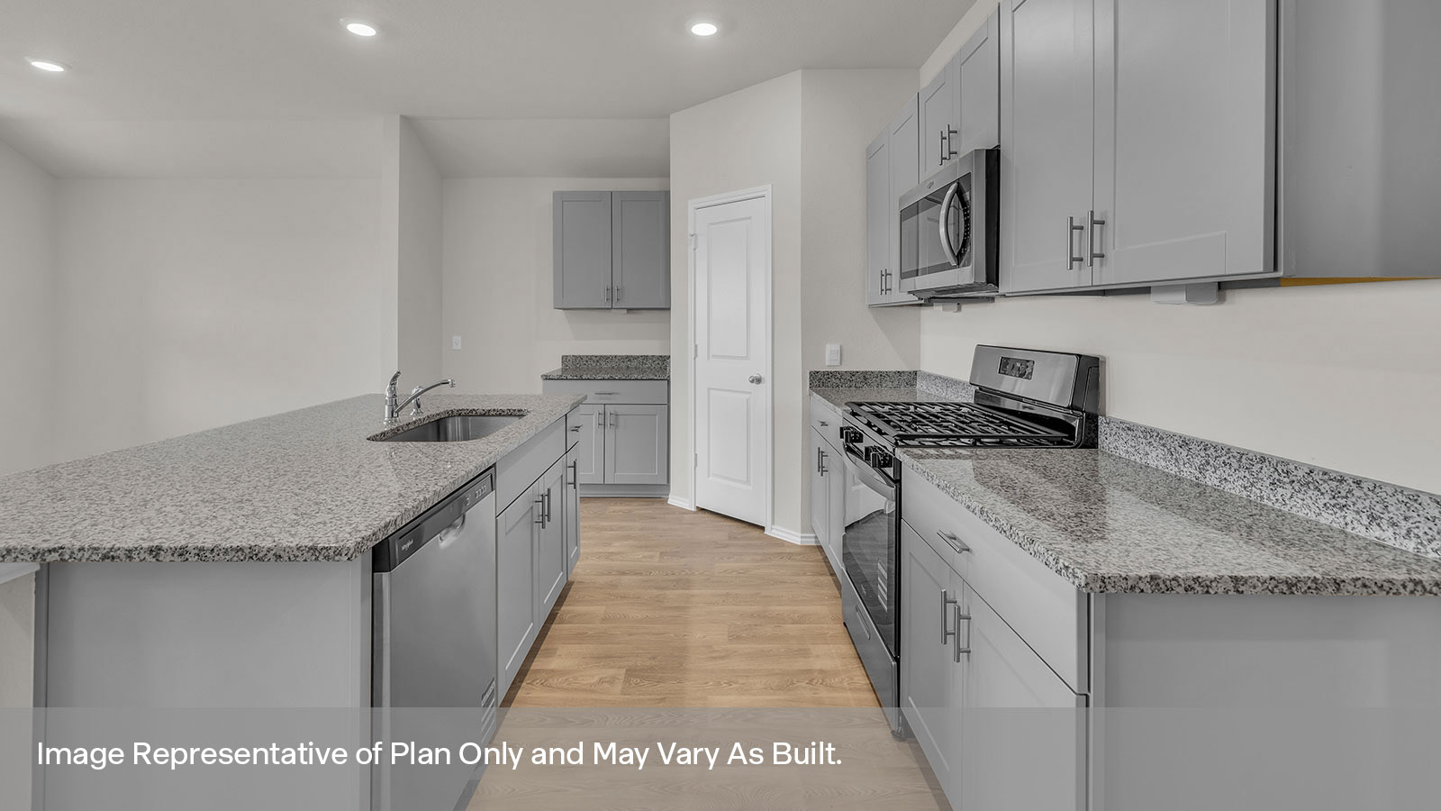 Kitchen with a kitchen island and large sink and appliances.