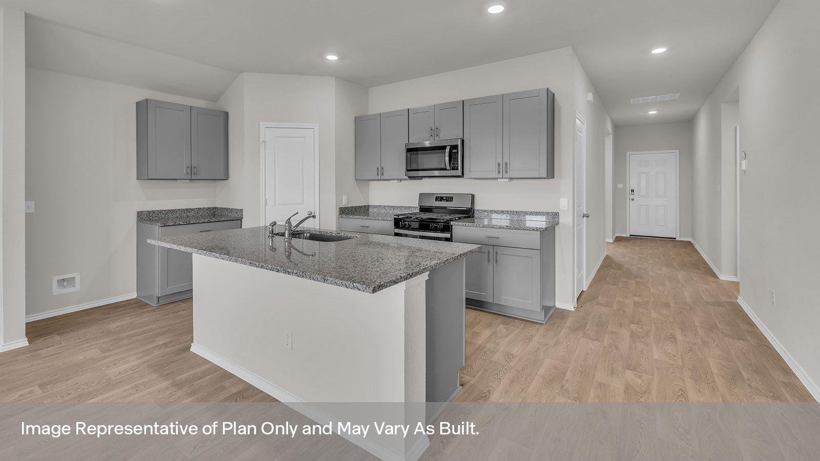 Kitchen with a kitchen island, pantry and hallway.
