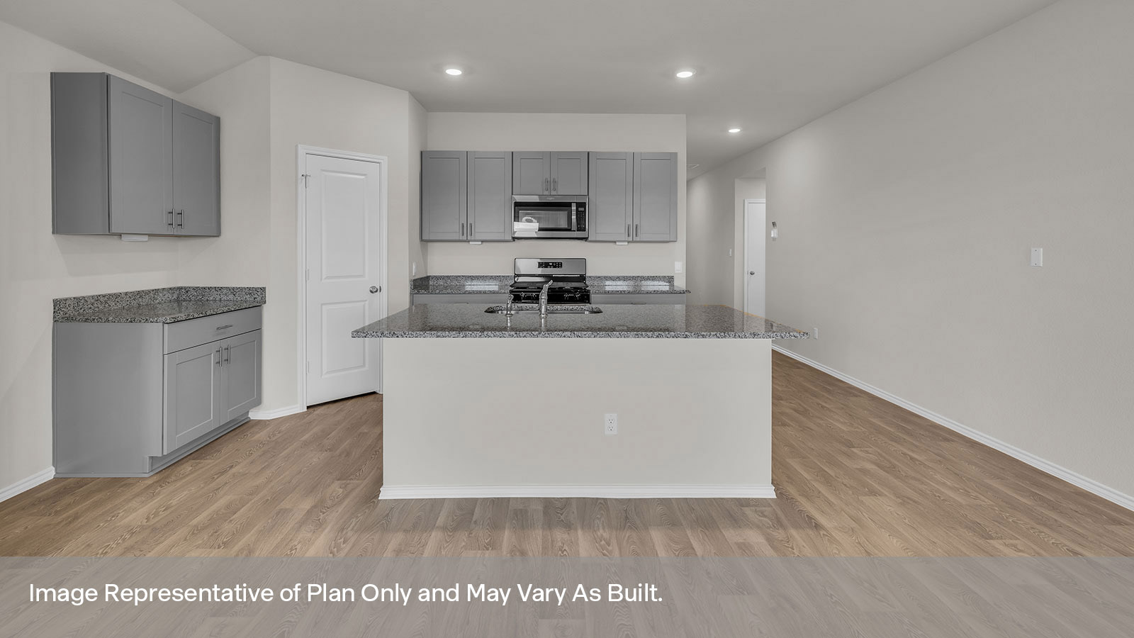 Kitchen with a kitchen island and front door entry.