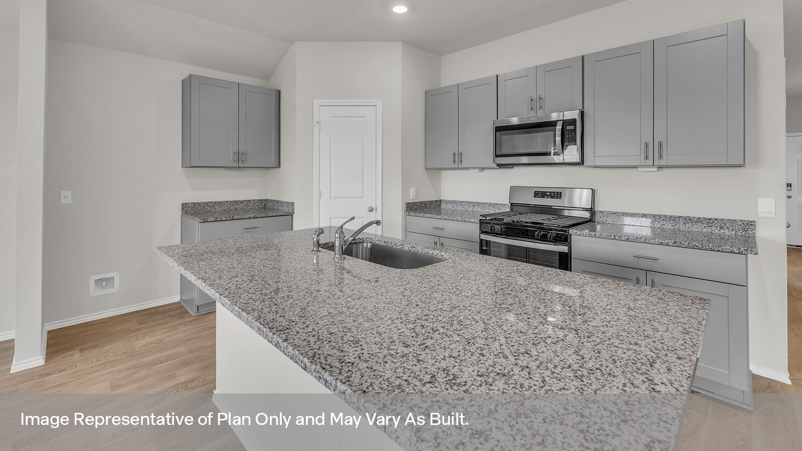Kitchen with a kitchen island and large sink and appliances.