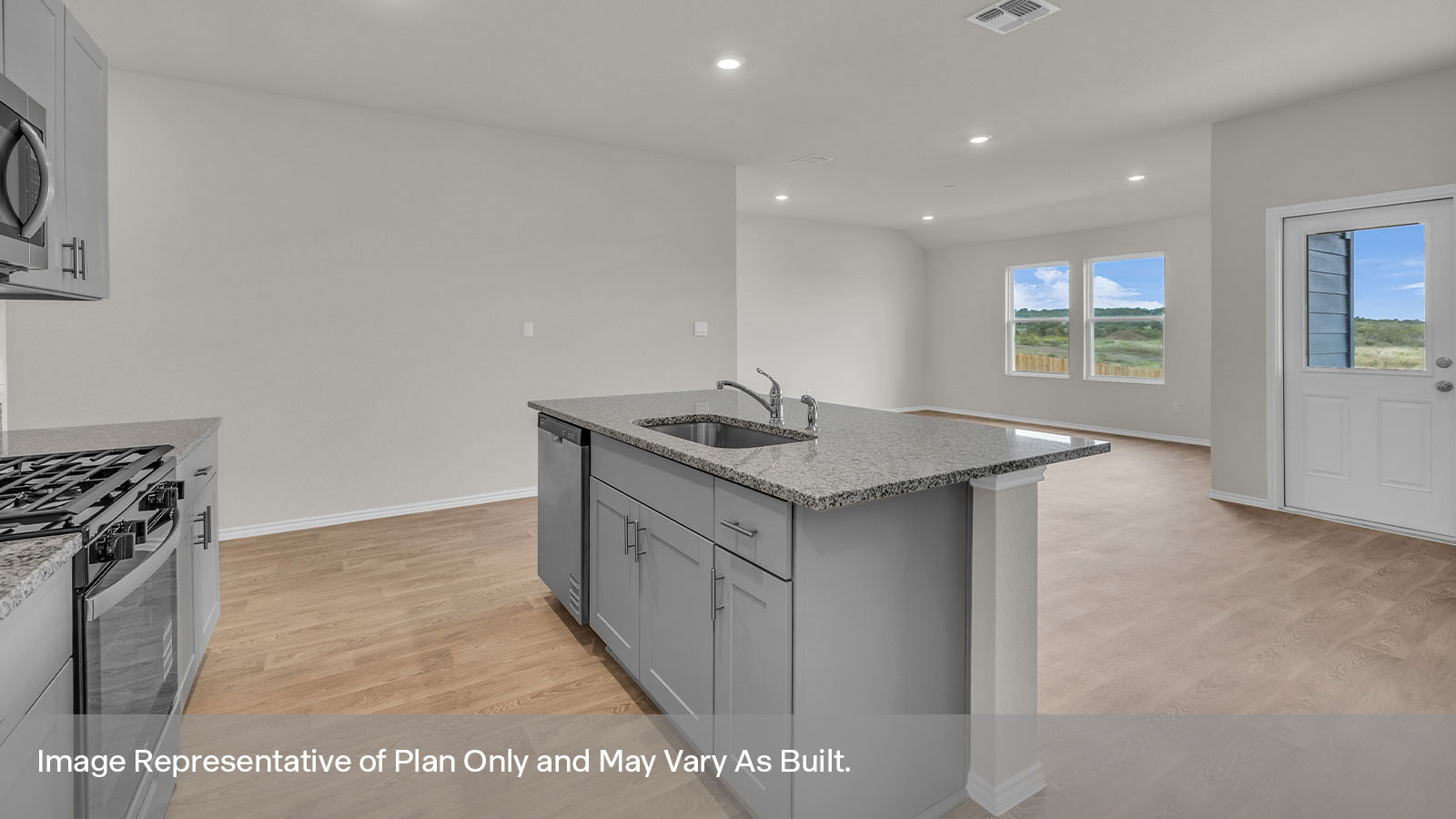 Kitchen with a kitchen island and large sink looking into the dining area.