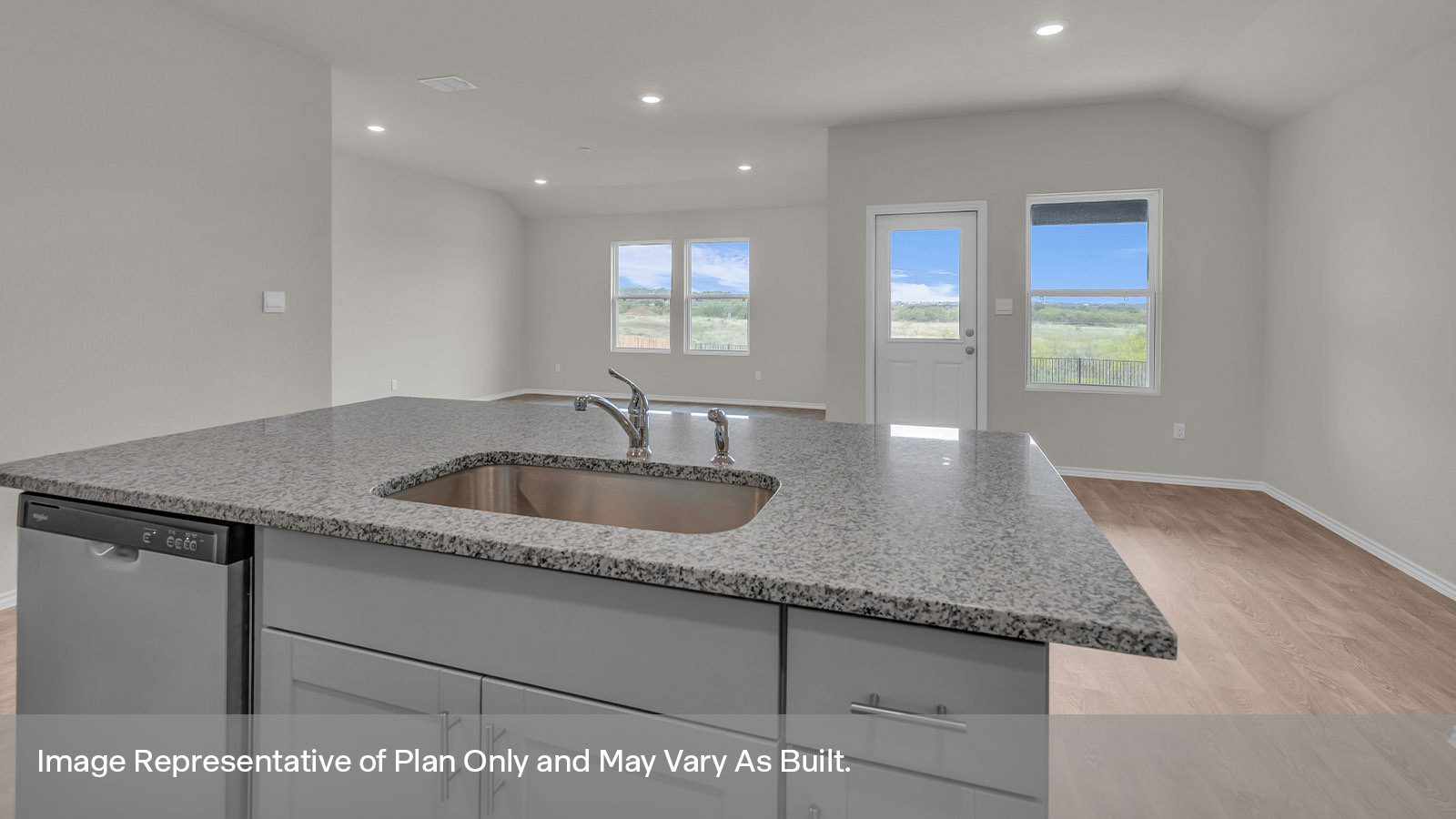 Kitchen with a kitchen island and large sink looking into the dining area.