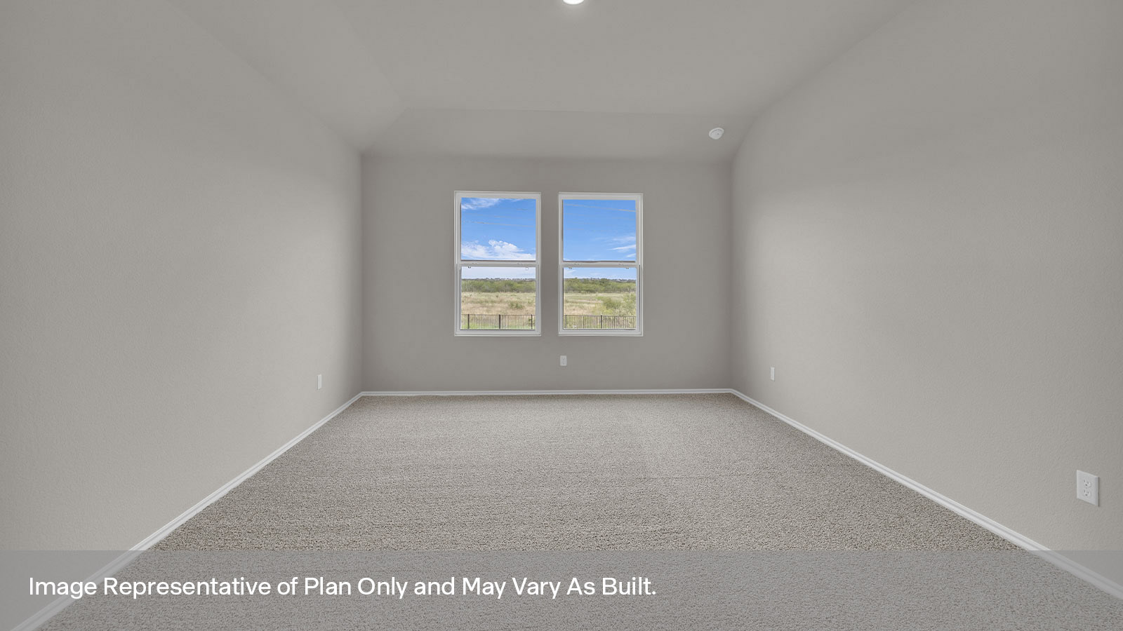 Main bedroom with carpet and two windows.