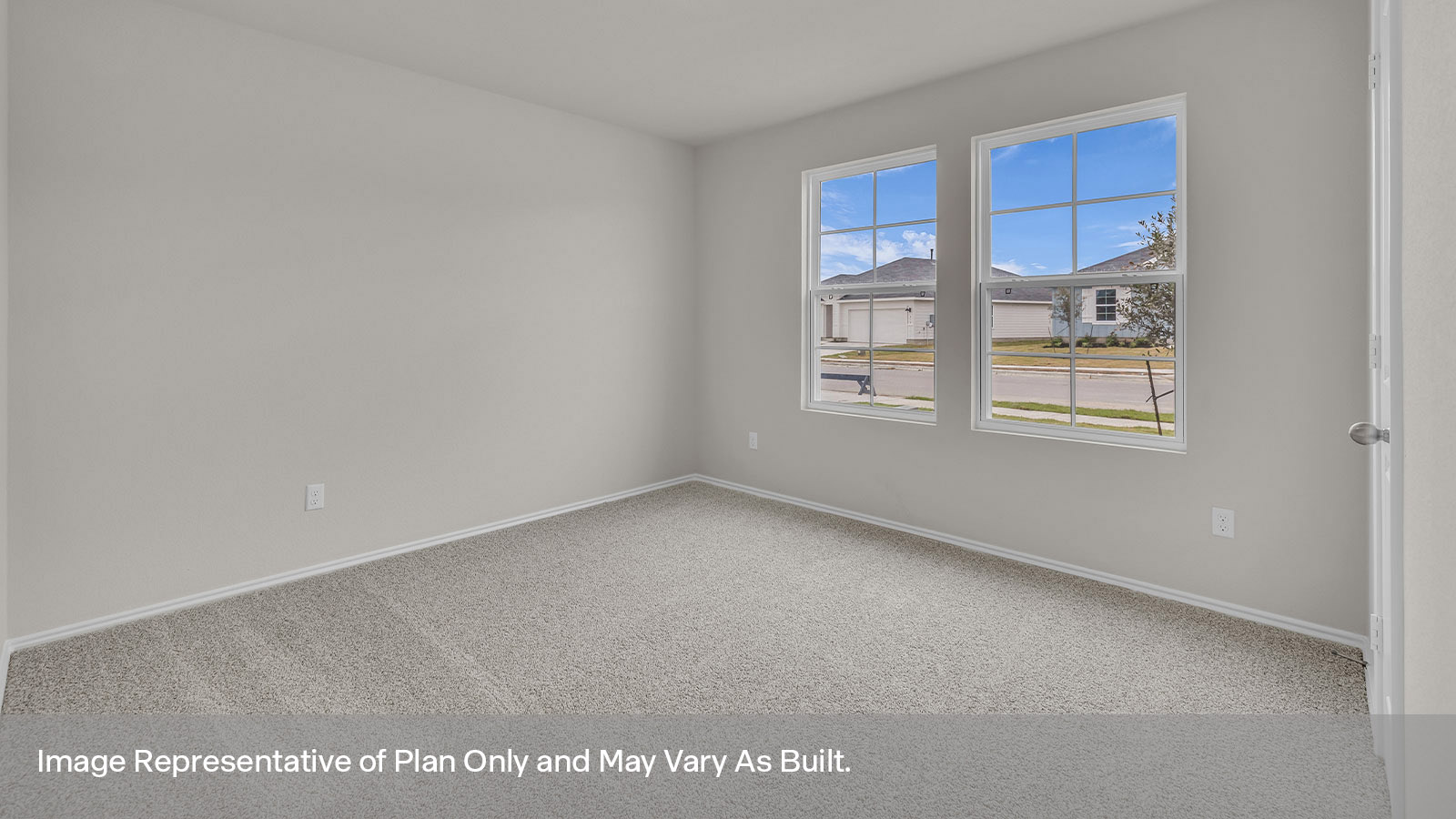 Front bedroom with carpeting and a window showing the front yard.