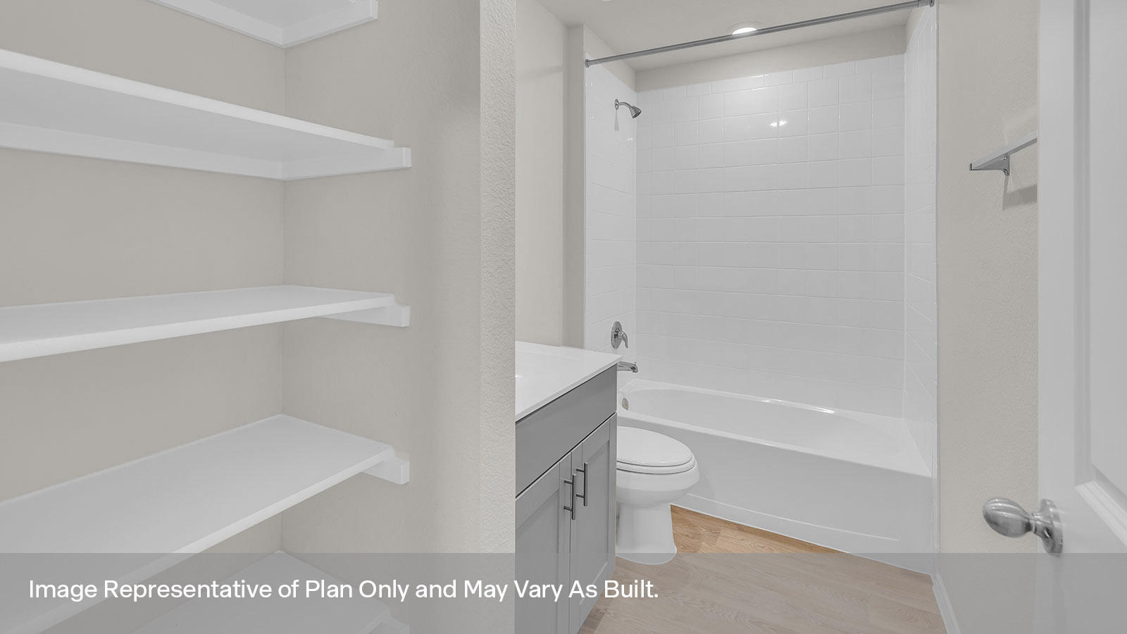 Bathroom with a tile surround shower/tub combo, single sink, and white cabinets.