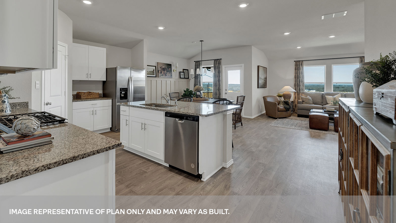 Kitchen with a kitchen island and large sink looking into the living room and dining area.