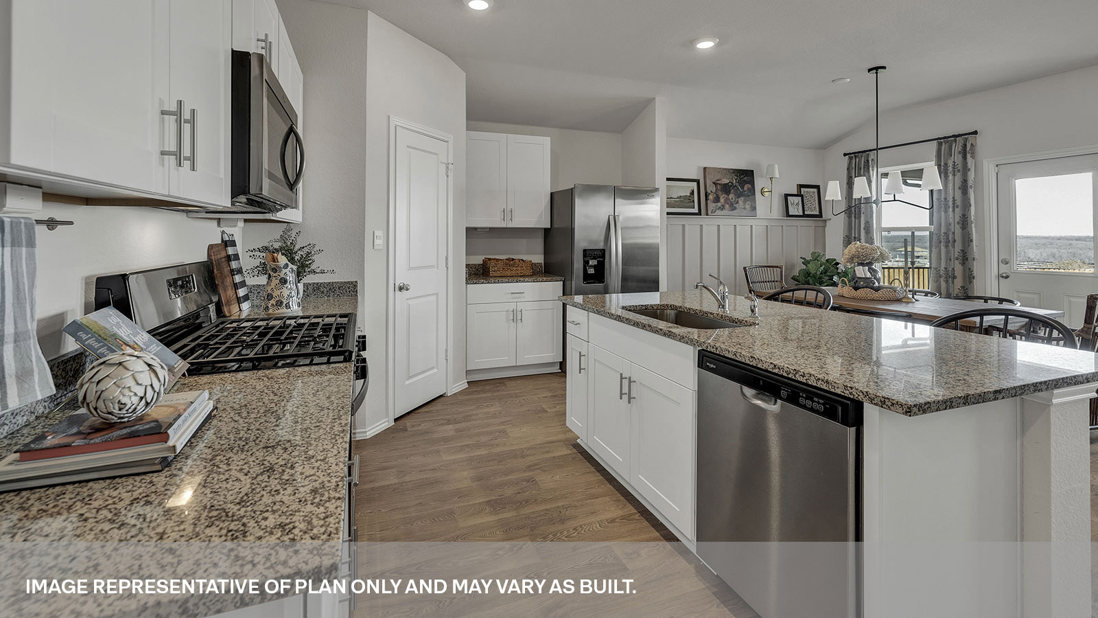 Kitchen with a kitchen island and large sink looking into the dining area.