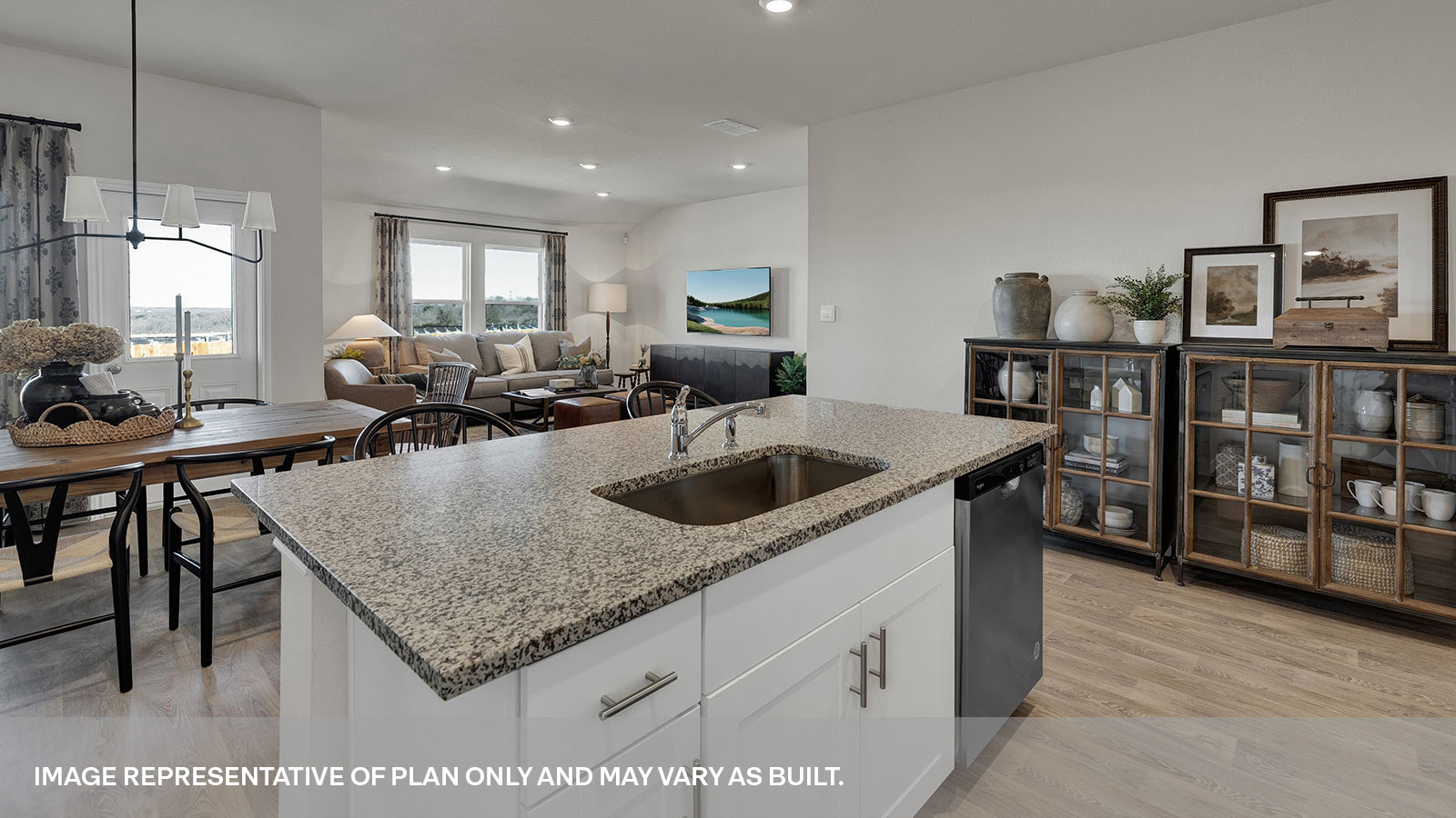 Kitchen island and large sink looking into the living room and dining area.