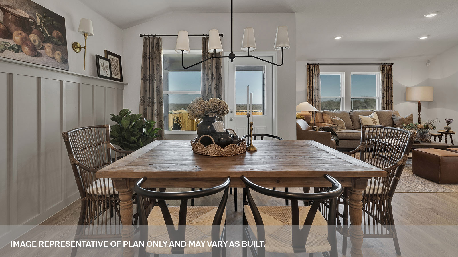 Dining area with 1 large window and a backdoor and living room with two large windows.