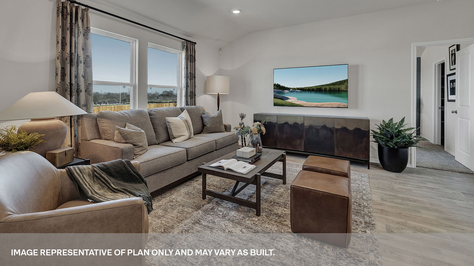 Living room with two large windows and entrance to the main bedroom.