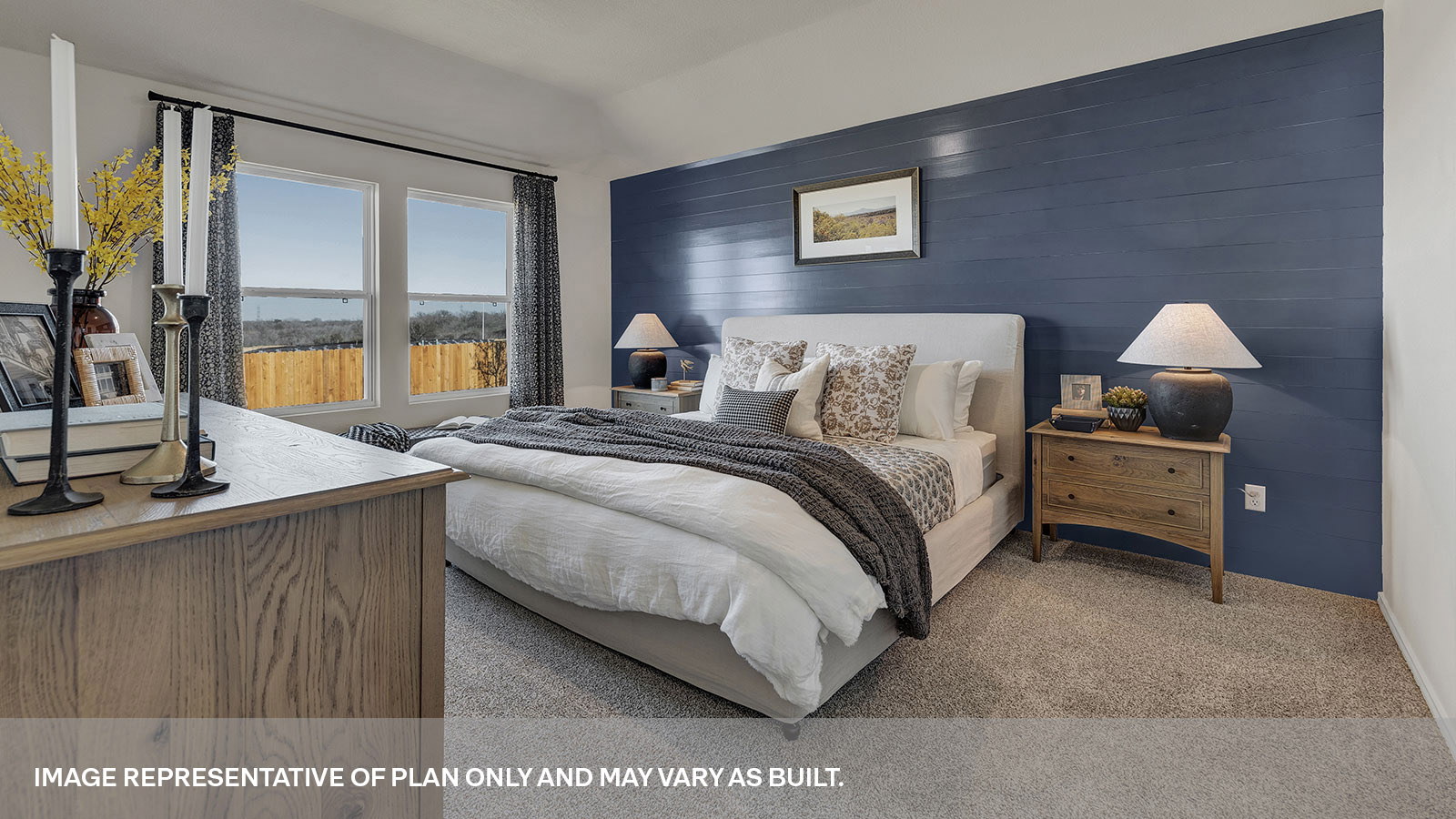 Main bedroom with carpet and two windows.