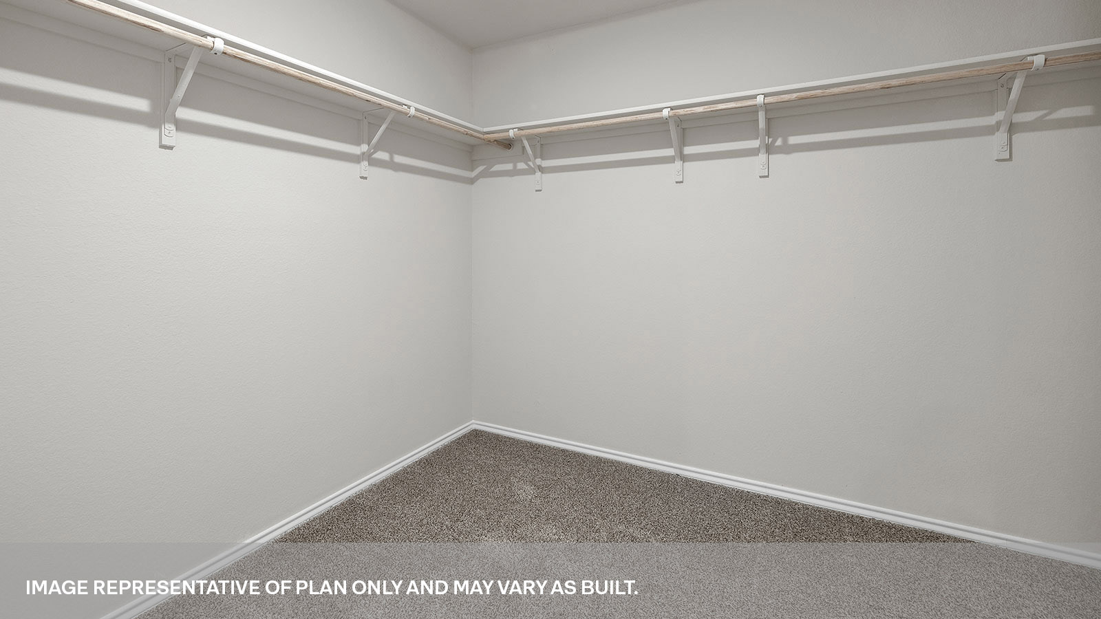 Walk-in closet with wooden shelves.