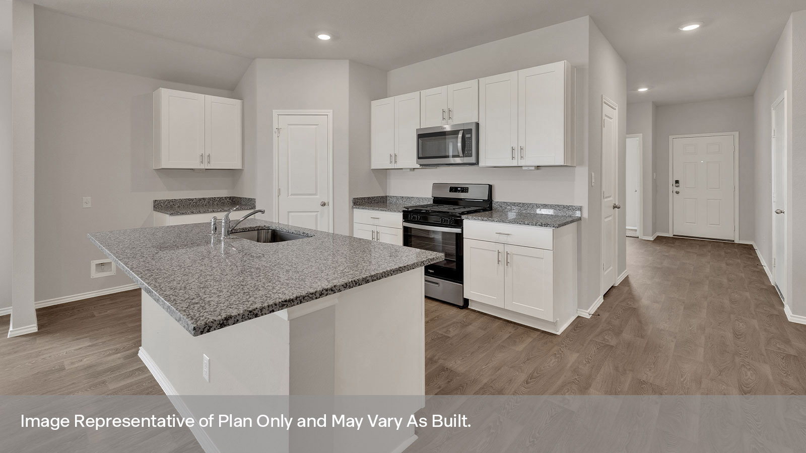Kitchen with kitchen island and entry hallway.