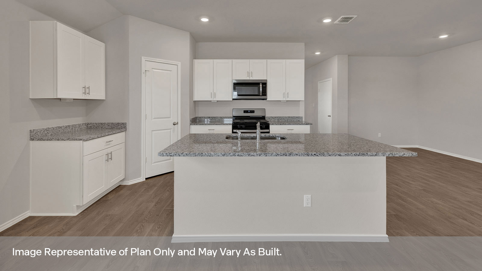 Kitchen with kitchen island and white cabinets.