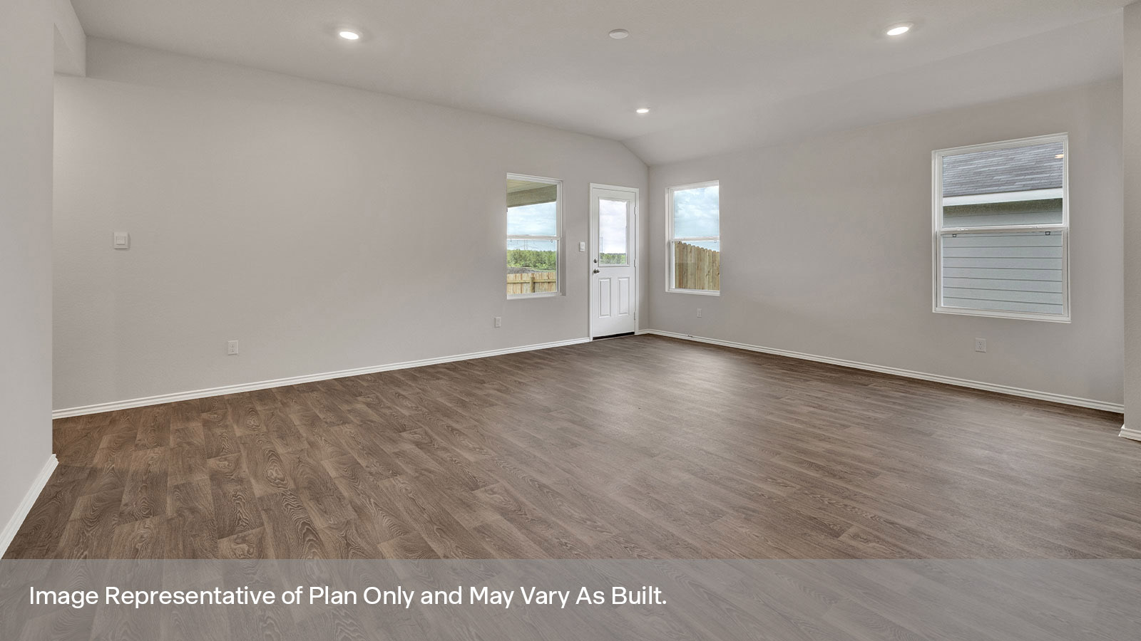 Living room with vinyl flooring, 3 windows, and half lite exterior door.
