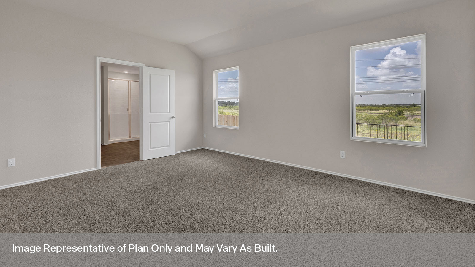 Main bedroom with carpeting and two windows.