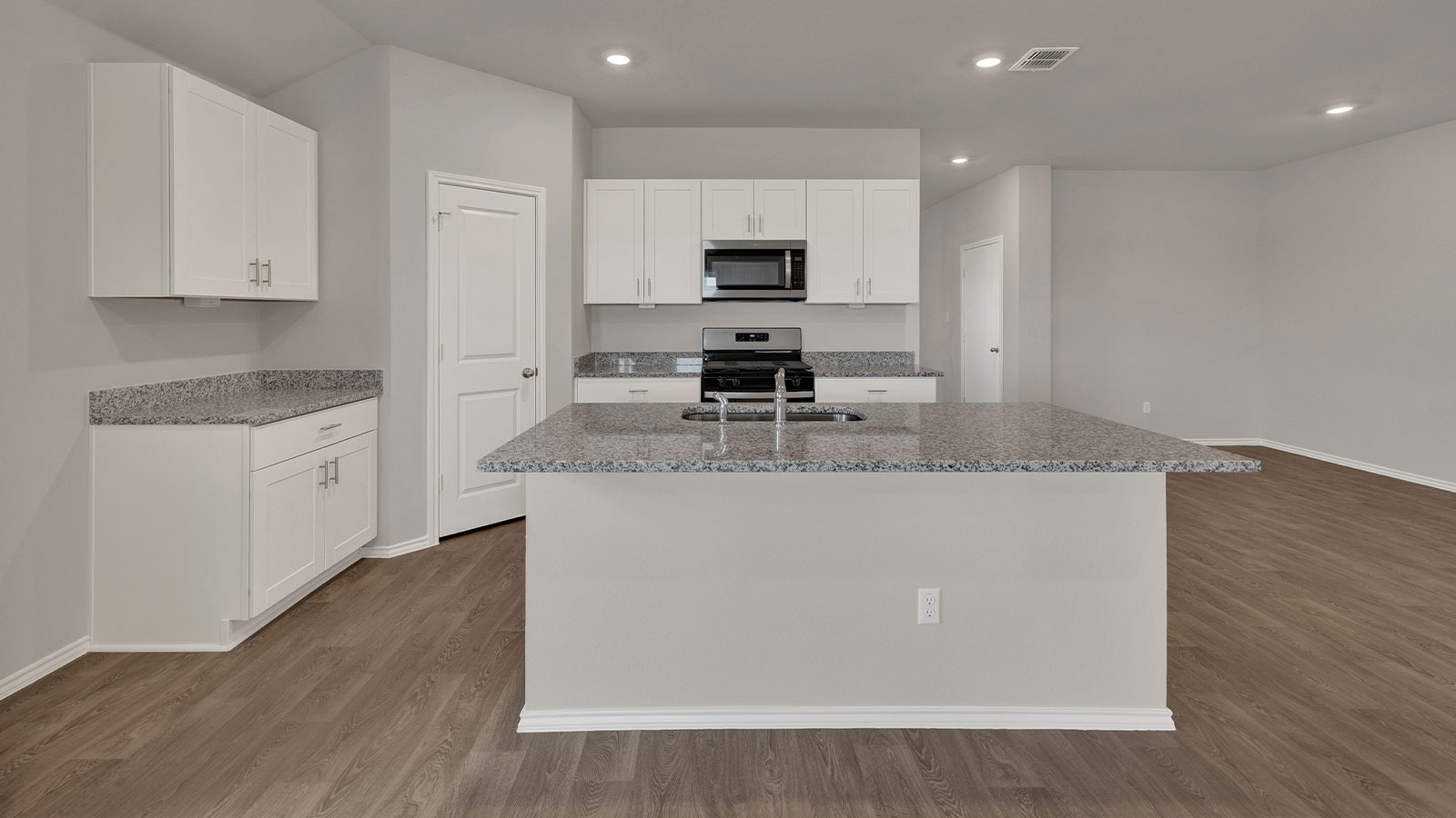 Kitchen with kitchen island and entry hallway.