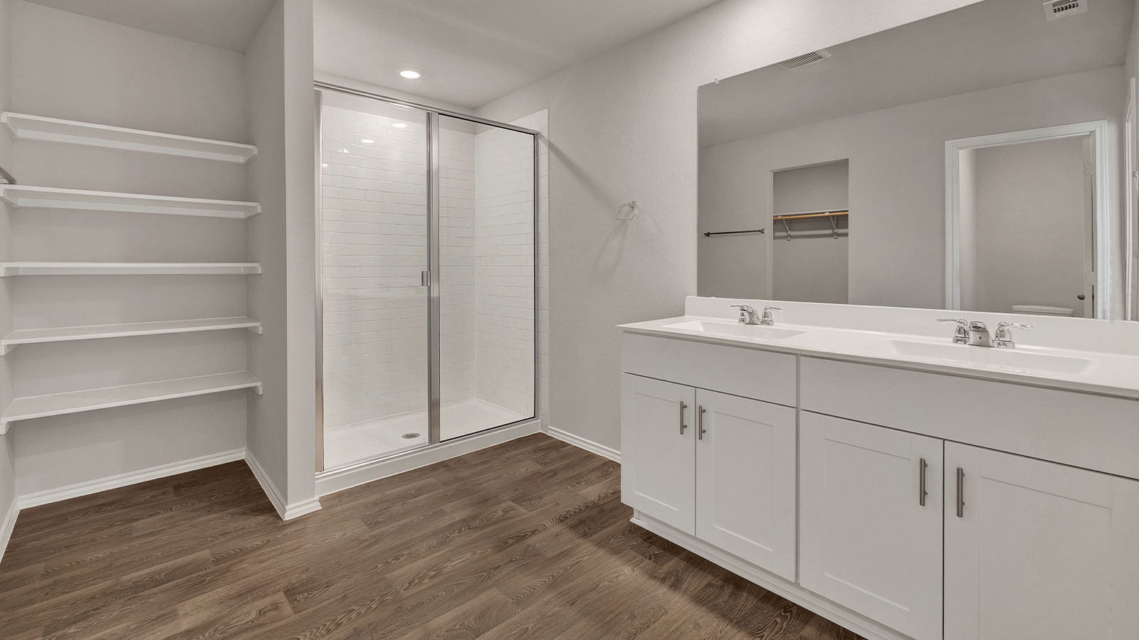 Main bathroom with vanity, walk-in shower, and wooden shelving.