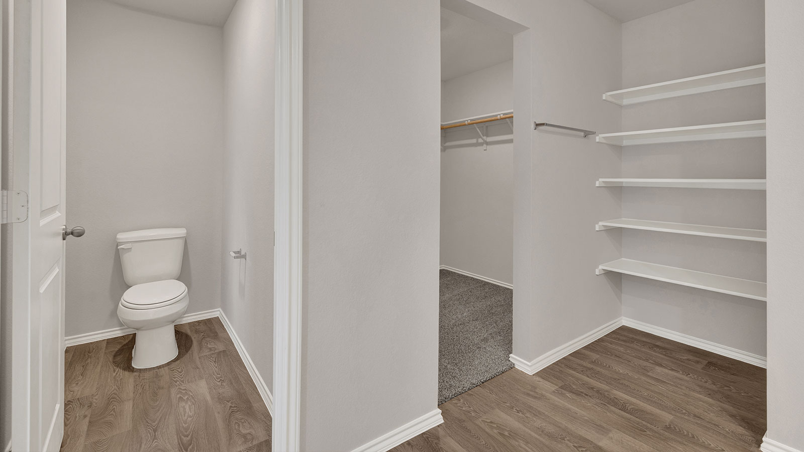 Main bathroom with vanity, walk-in shower, and wooden shelving.