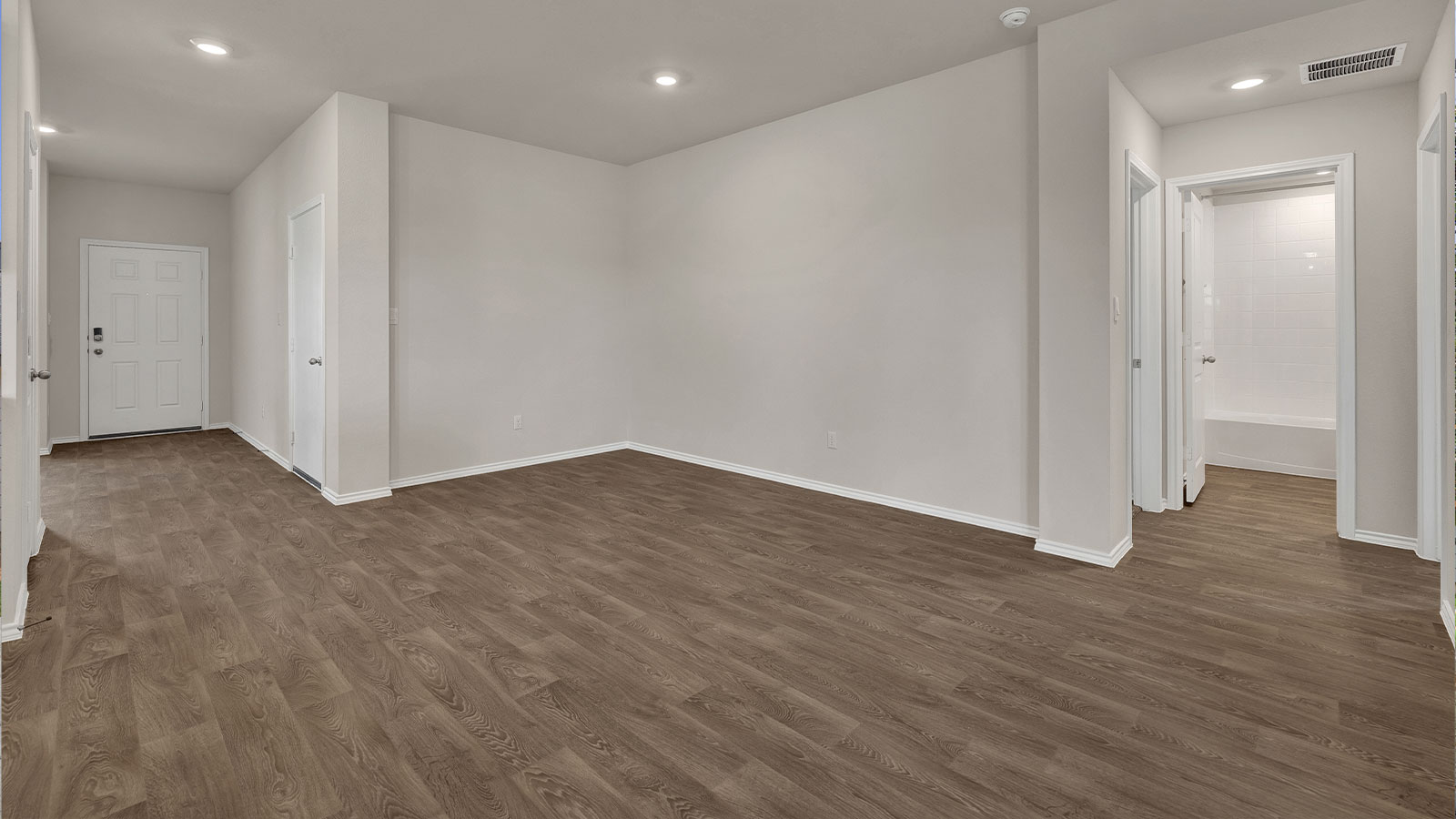 Entry hallway with vinyl flooring and front door.