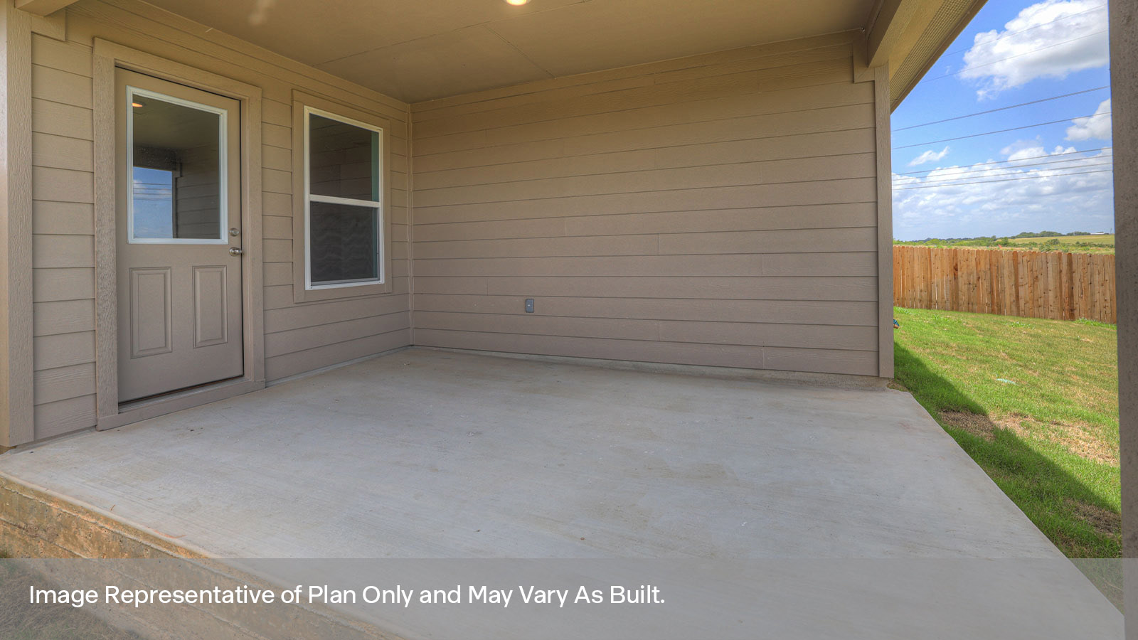 Covered back patio with privacy fence.