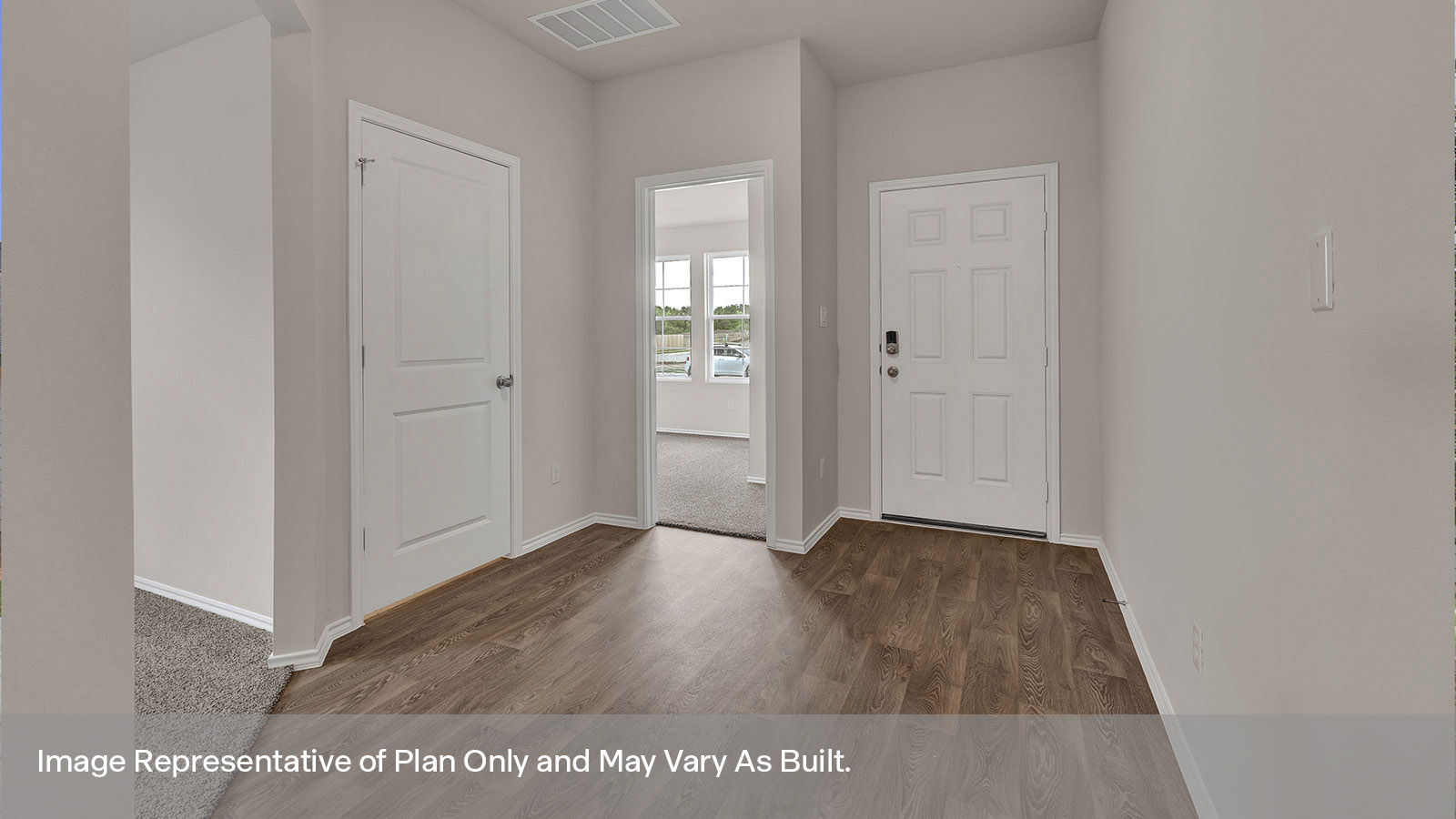 Entry hallway with vinyl flooring and front door.