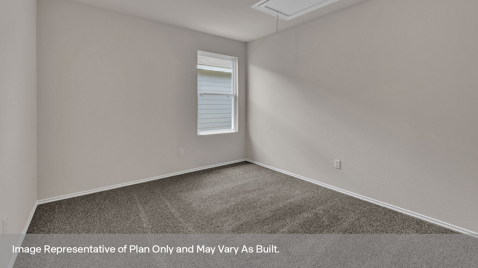 Study with carpeting and a window showing the side yard.