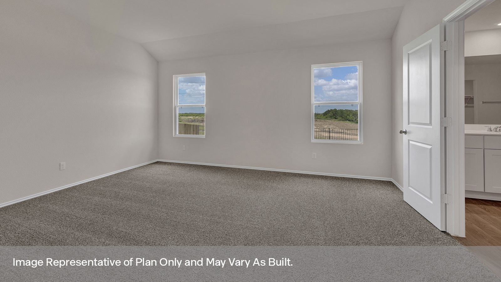 Main bedroom with carpet and two windows.