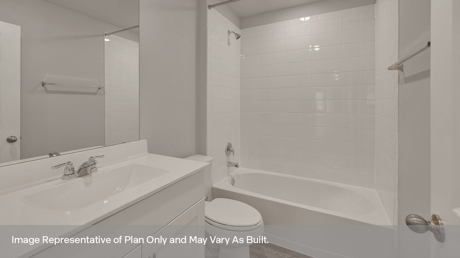 Third Bathroom with a tile surround shower/tub combo, single sink,and white cabinets.