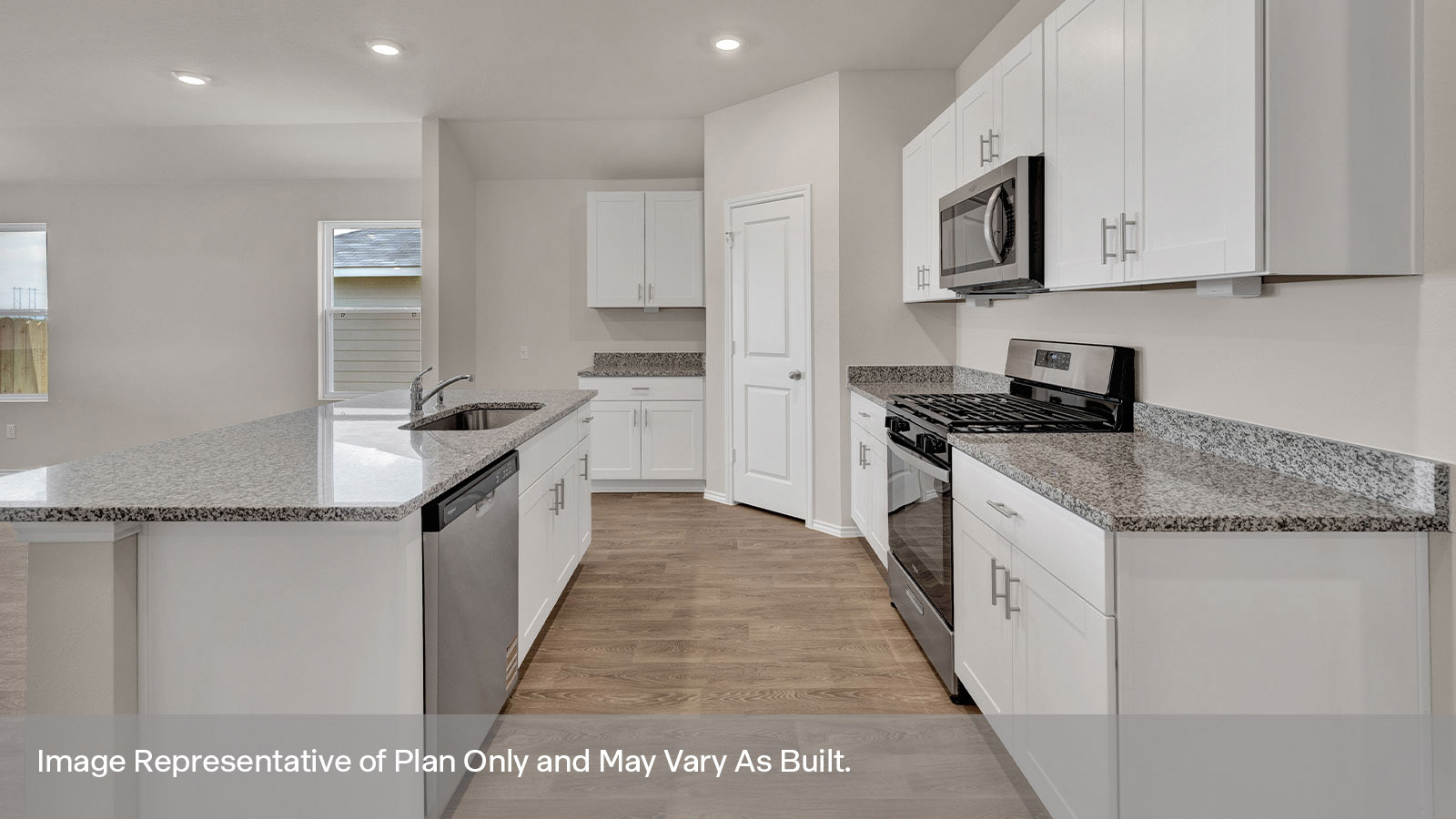 Kitchen with kitchen island and white cabinets.