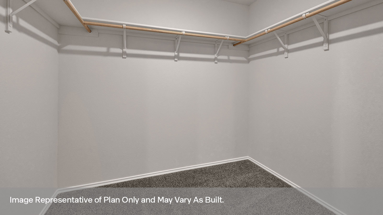 Main bedroom with carpeting and wooden shelving.