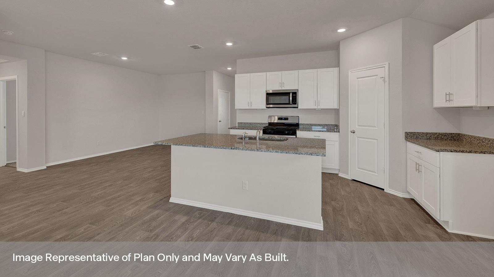 Kitchen with kitchen island and entry hallway.