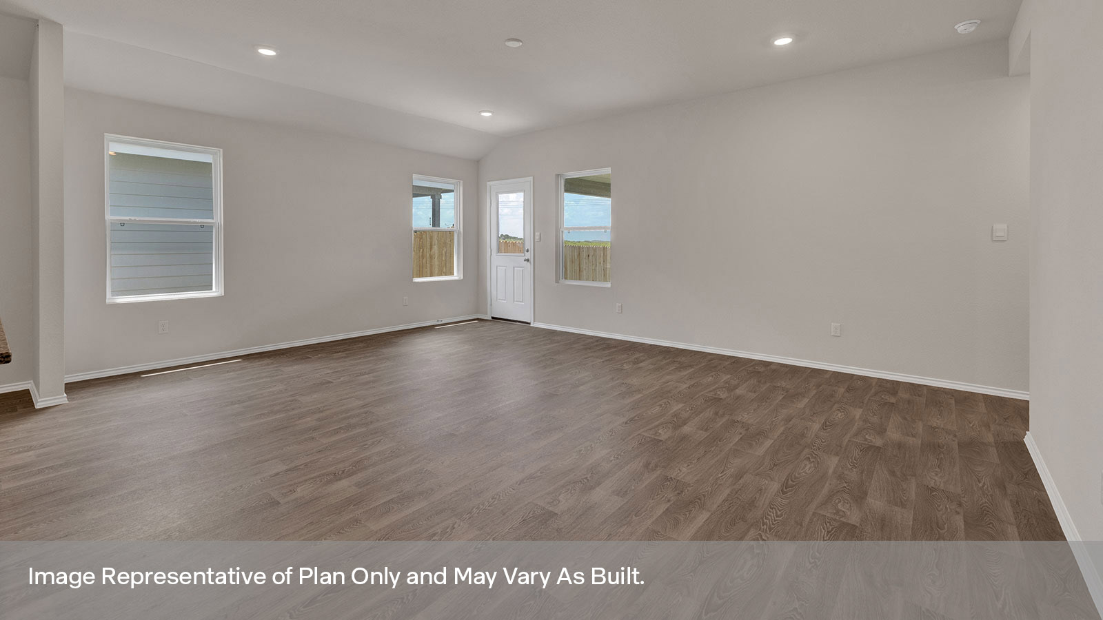 Living room with vinyl flooring, 3 windows, and half lite exterior door.