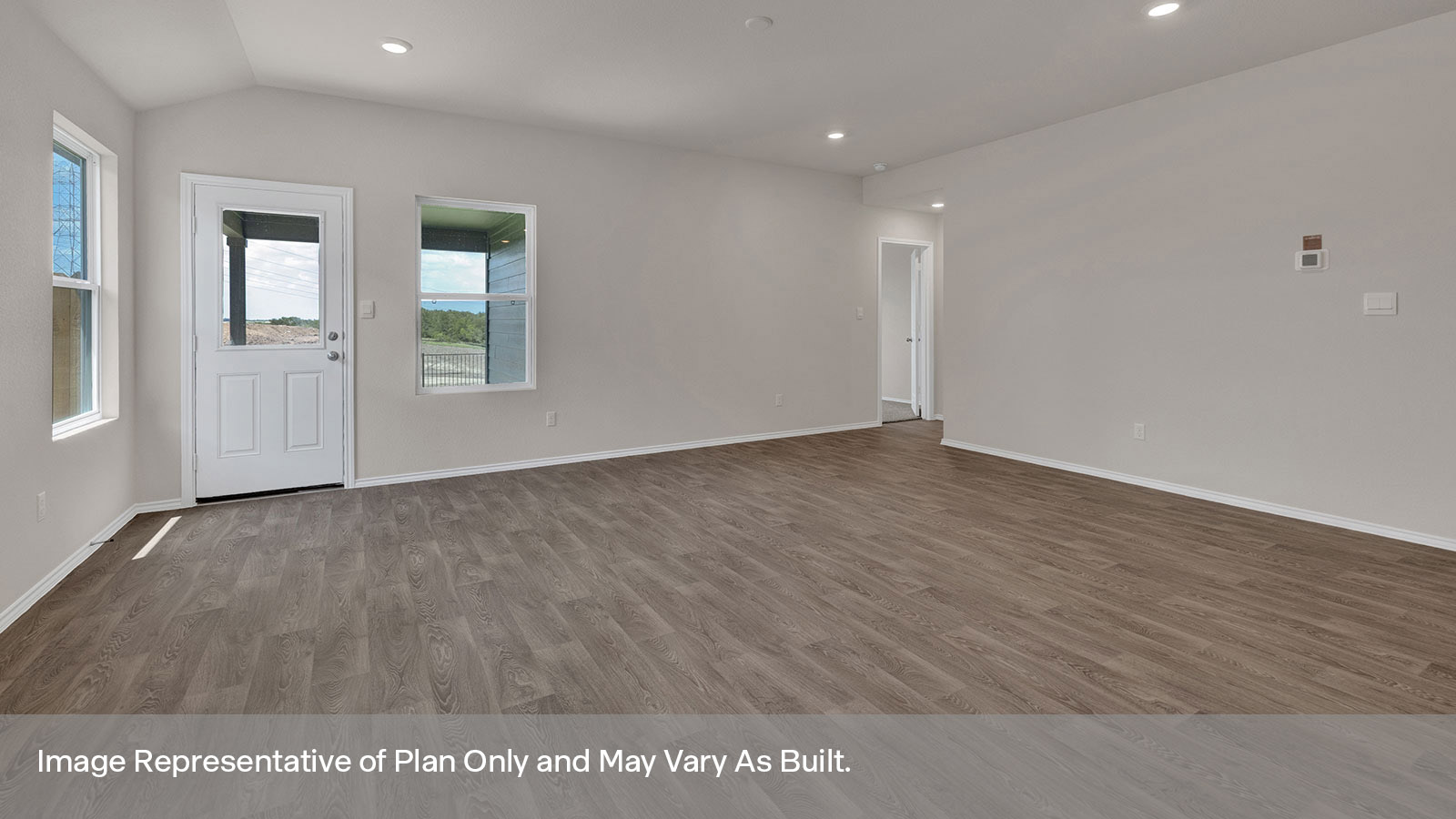 Living room with vinyl flooring opening to the main bedroom.