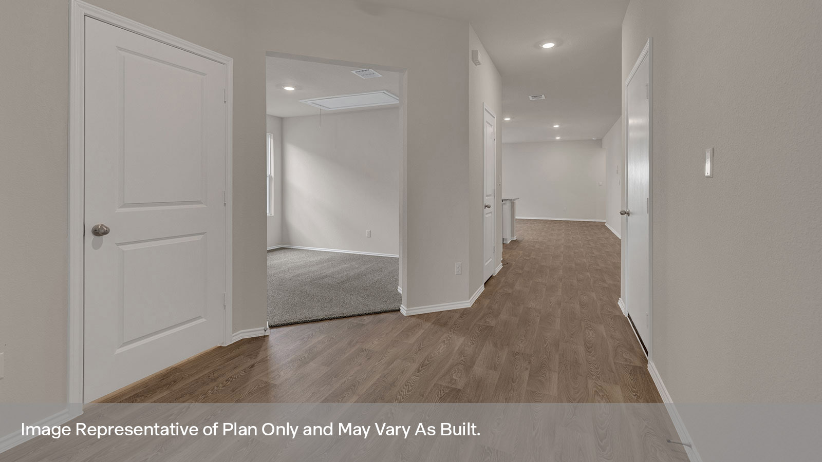 Entry hallway with vinyl flooring and front door.