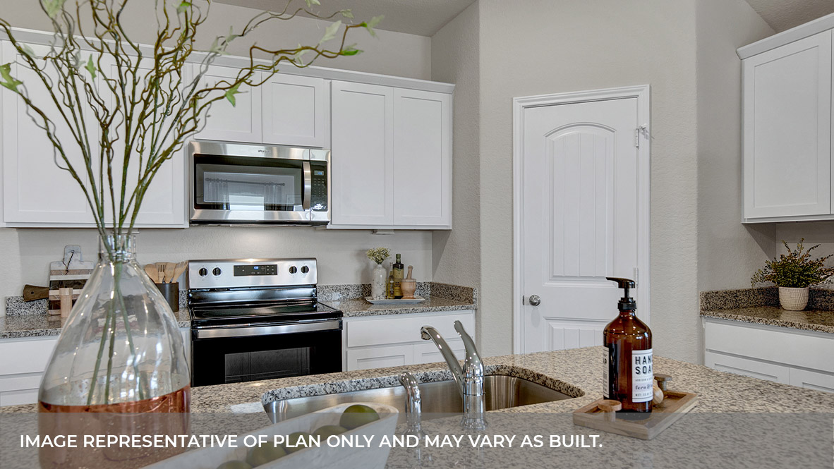 Kitchen with kitchen island and white cabinets.