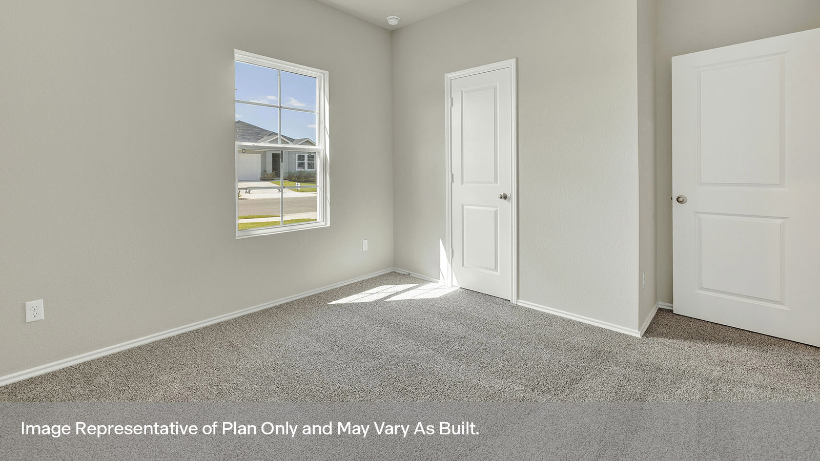 Front bedroom with carpeting and two windows.