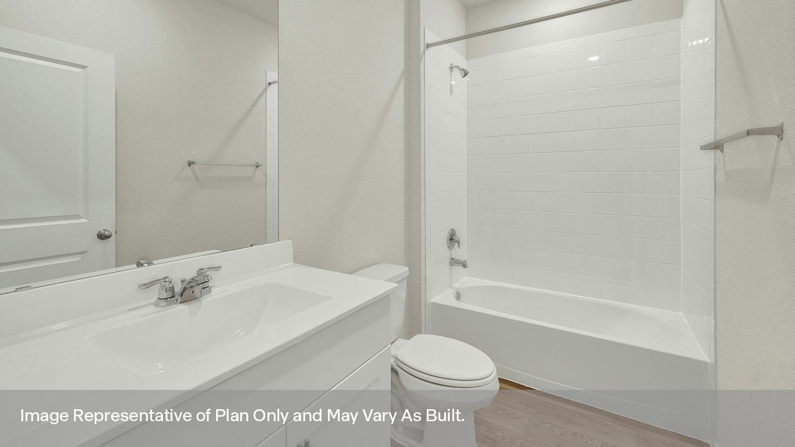 Bathroom with single sink vanity, toilet, and tile surround with tub/shower combo.