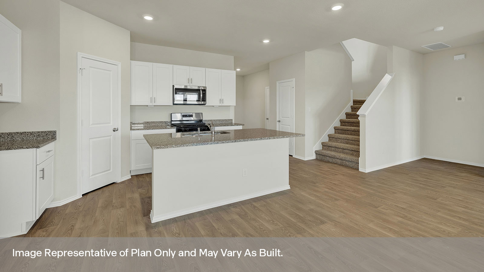 Kichen with kitchen island and stainless steel appliances.