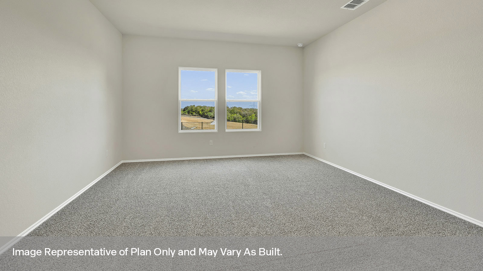 Main bedroom with carpeting and two windows.